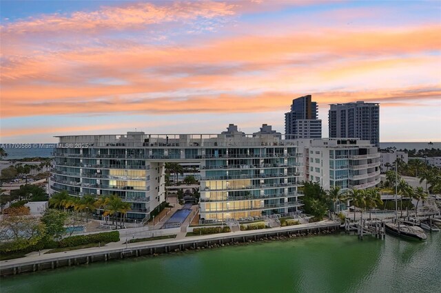 bird's eye view with a water view and a beach view