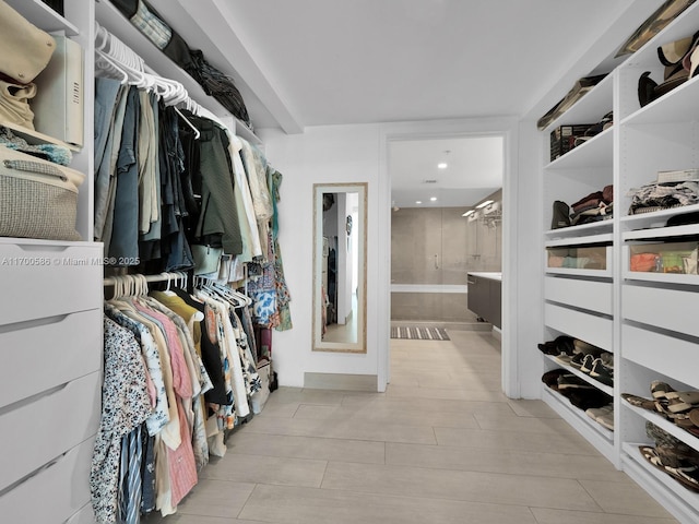 walk in closet with light wood-type flooring