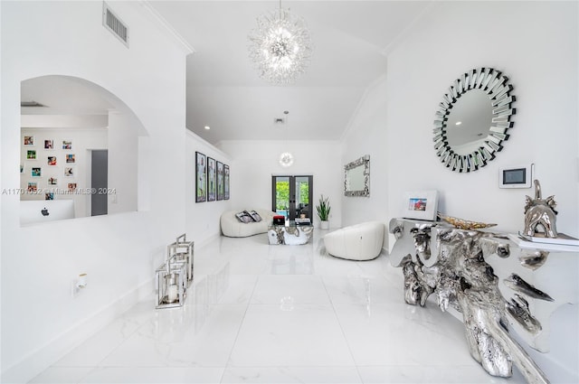 living room with a notable chandelier, crown molding, and french doors