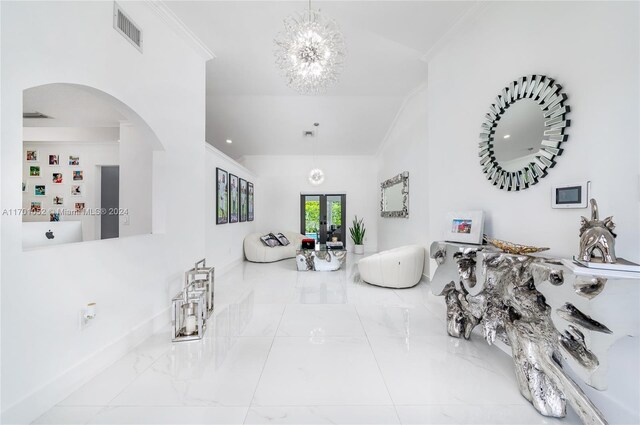 9701 SW 56th Ter, Miami, FL 33173 - living area featuring ornamental molding, arched walkways, french doors, a chandelier, and lofted ceiling