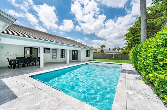 view of swimming pool with french doors and a patio