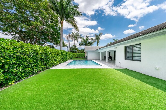 9701 SW 56th Ter, Miami, FL 33173 - view of swimming pool featuring a yard and a patio