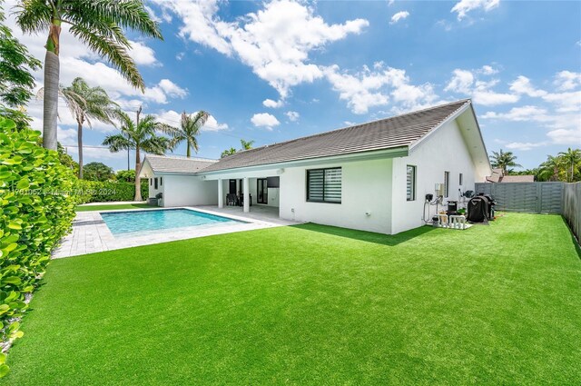 9701 SW 56th Ter, Miami, FL 33173 - rear view of house with stucco siding, a patio area, and a tiled roof