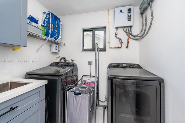 9701 SW 56th Ter, Miami, FL 33173 - laundry area featuring independent washer and dryer, cabinet space, and tankless water heater