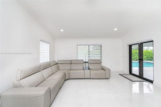 living room featuring lofted ceiling, ornamental molding, and a wealth of natural light