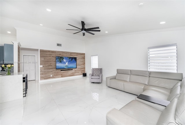 living room with ceiling fan and crown molding