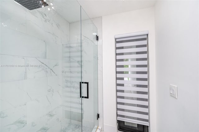 bathroom featuring a shower with shower door