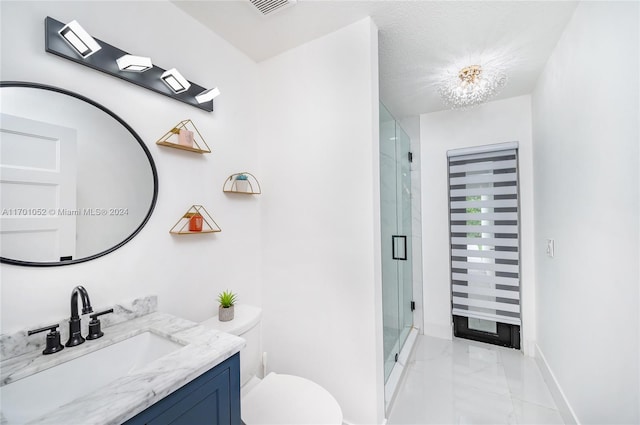 bathroom featuring a shower with door, vanity, a notable chandelier, and toilet