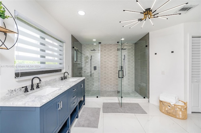 bathroom featuring a shower with door, vanity, and an inviting chandelier