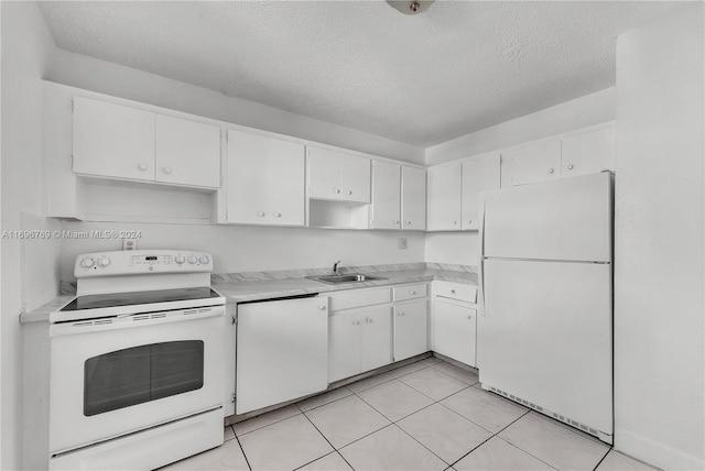 kitchen featuring sink, white cabinets, and white appliances