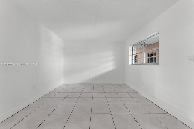 spare room with light tile patterned floors