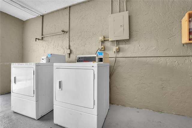 clothes washing area with independent washer and dryer and electric panel