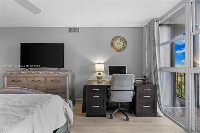 bedroom with access to outside, a textured ceiling, and ceiling fan