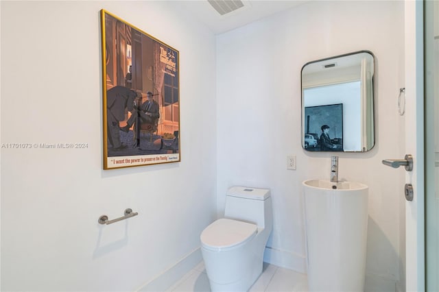 bathroom featuring tile patterned floors and toilet