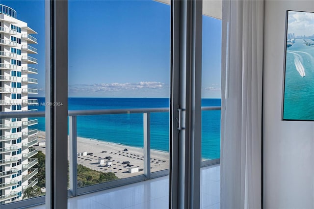 interior space with a beach view and a water view