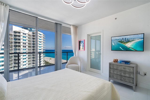 bedroom featuring light tile patterned floors, access to outside, and multiple windows