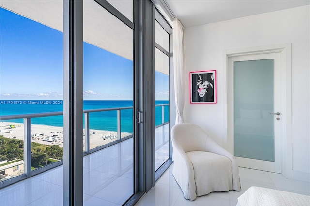 tiled bedroom featuring a beach view and a water view