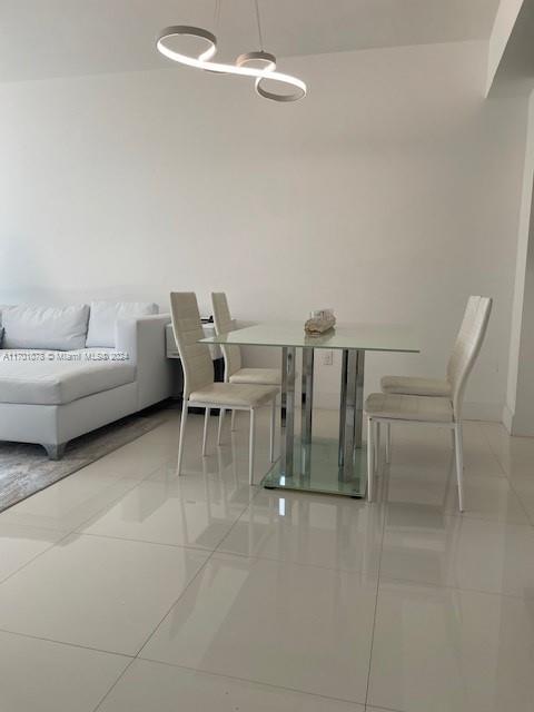 unfurnished dining area with light tile patterned floors