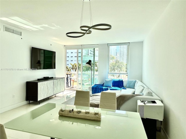 living room with floor to ceiling windows and a notable chandelier