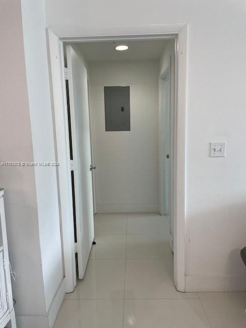 hallway featuring light tile patterned flooring and electric panel