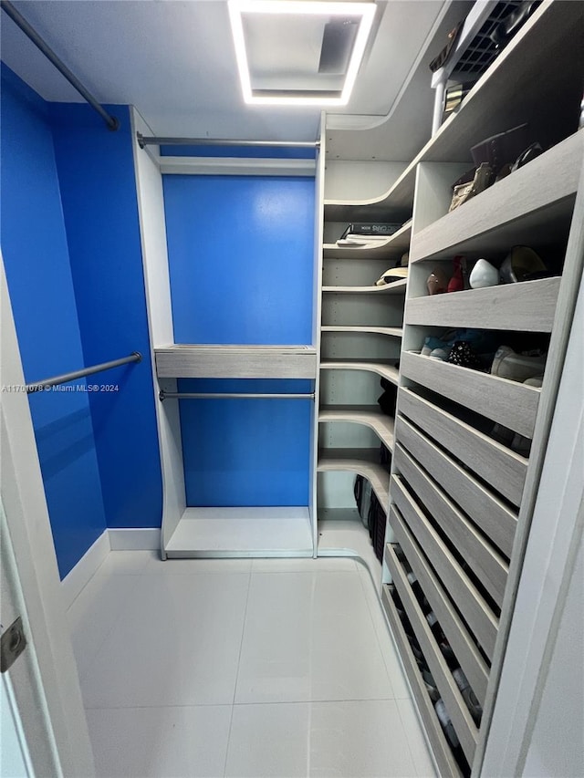 spacious closet featuring tile patterned flooring