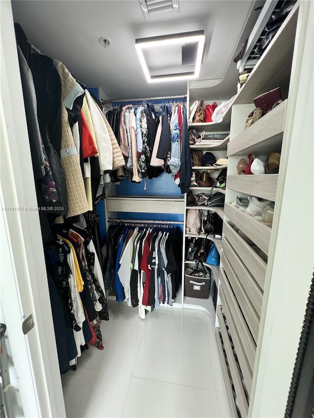 walk in closet with tile patterned floors