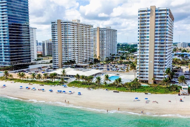 view of property with a beach view and a water view