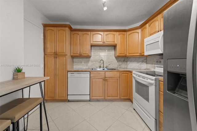 kitchen with tasteful backsplash, sink, white appliances, and light tile patterned flooring