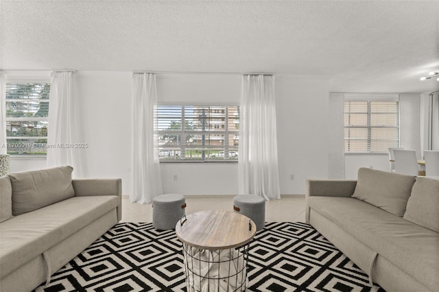 tiled living room featuring a textured ceiling