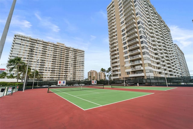 view of tennis court with basketball hoop