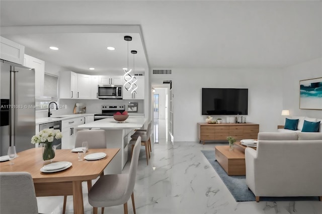 dining area with a wealth of natural light and sink