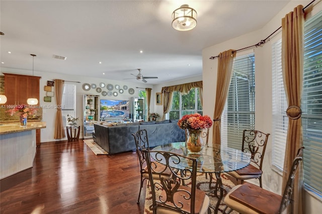 dining area with ceiling fan and dark wood-type flooring