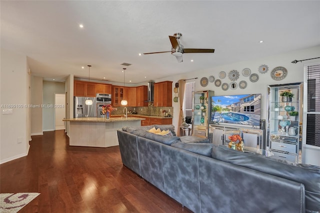 living room featuring ceiling fan and dark hardwood / wood-style flooring