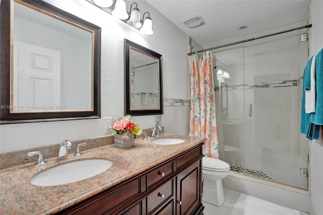 bathroom featuring tile patterned flooring, a shower with curtain, vanity, and toilet