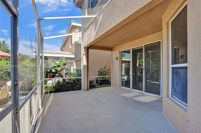 view of patio / terrace featuring glass enclosure