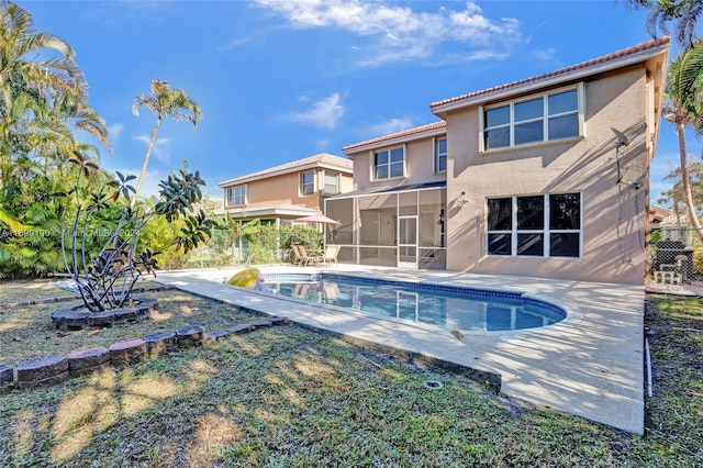 view of pool featuring a patio area and a sunroom