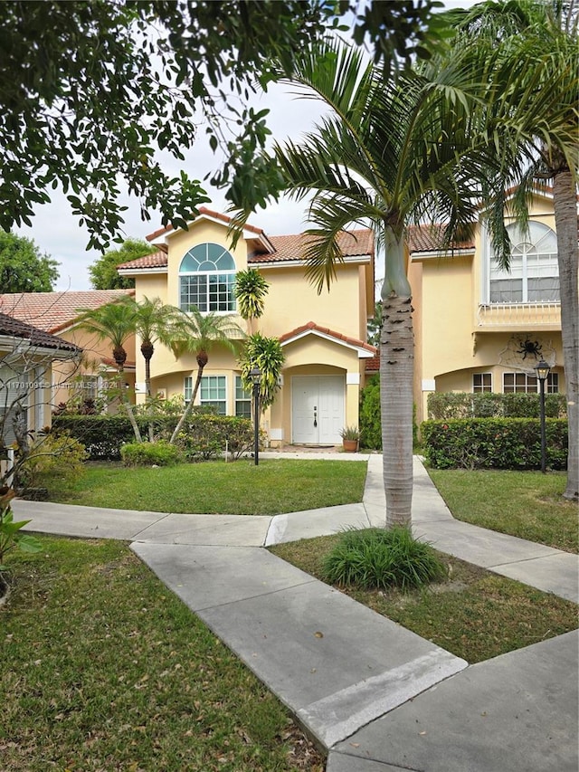 view of front of house with a garage and a front yard