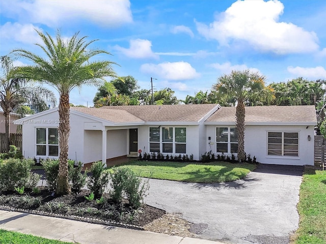 ranch-style home featuring a front yard