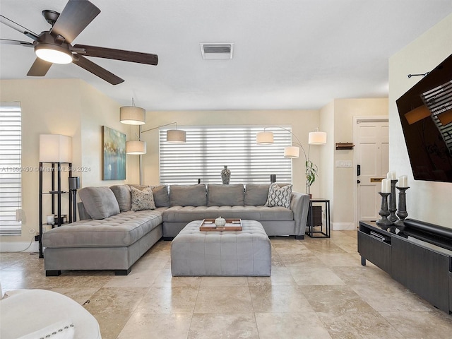 living room with a wealth of natural light and ceiling fan