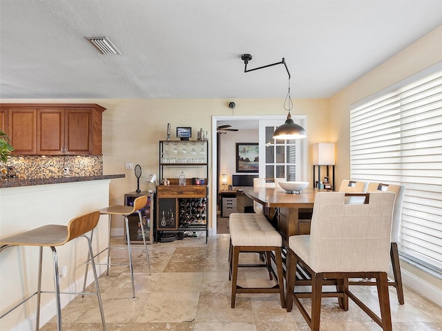 dining room featuring a textured ceiling