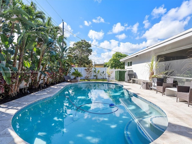 view of swimming pool with a patio area