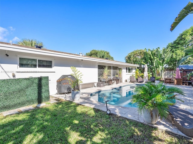 view of swimming pool featuring a lawn and a patio area