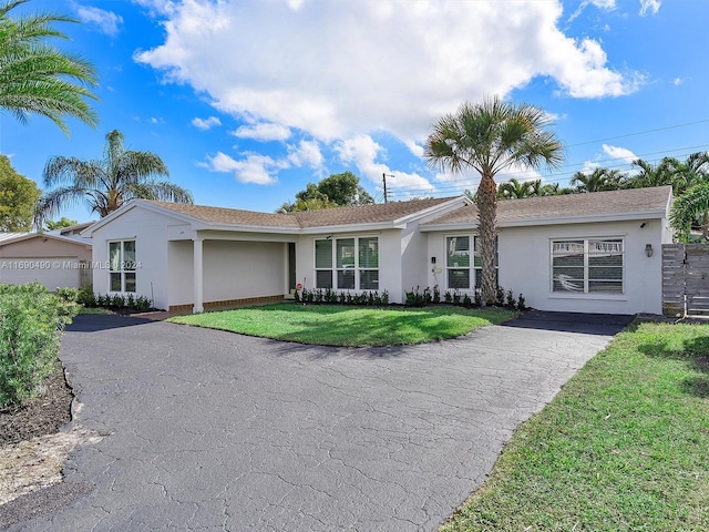 ranch-style home featuring a front yard