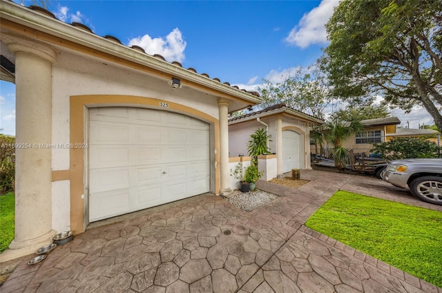 mediterranean / spanish home with a garage