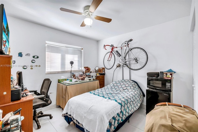 tiled bedroom featuring ceiling fan