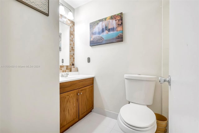 bathroom featuring tile patterned flooring, vanity, and toilet