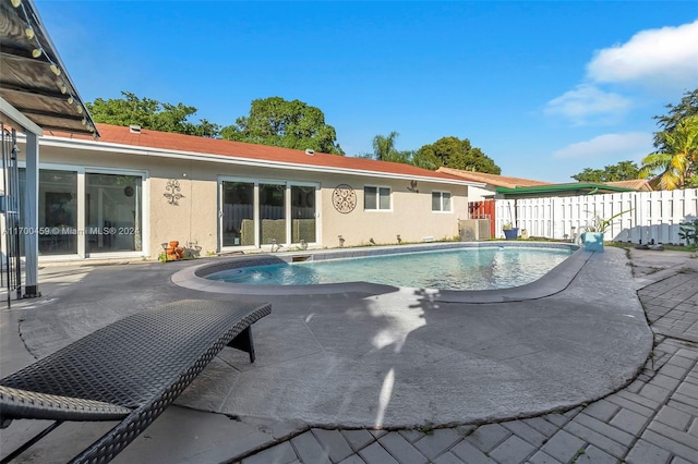 view of pool with central air condition unit and a patio area