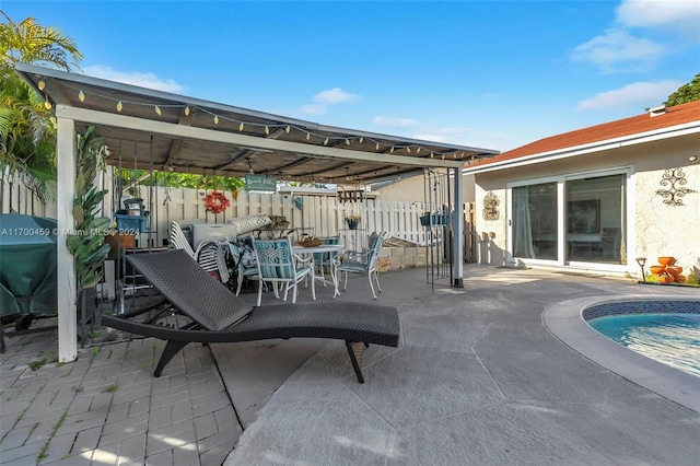 view of patio / terrace with a fenced in pool