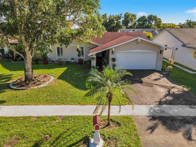 view of front of home with a garage and a front yard