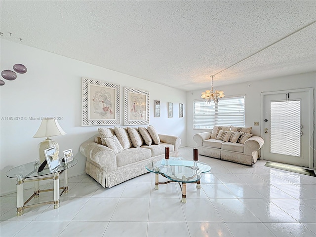 tiled living room featuring a textured ceiling and an inviting chandelier